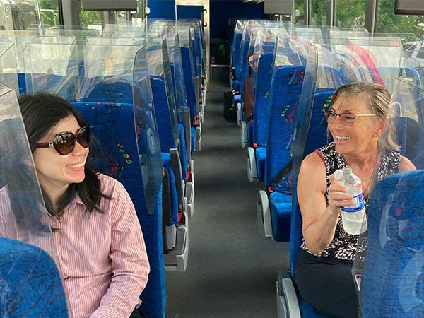Two women sit on the Northern Health Connections bus